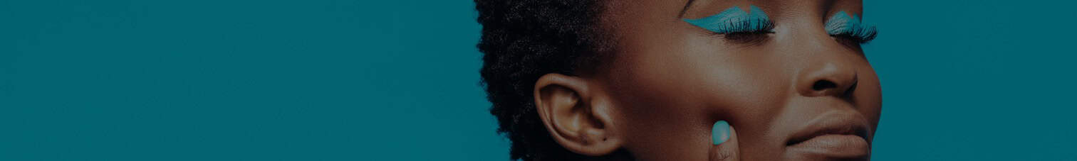 Empowered Black woman with natural hair and vibrant makeup, celebrating Black culture and beauty.