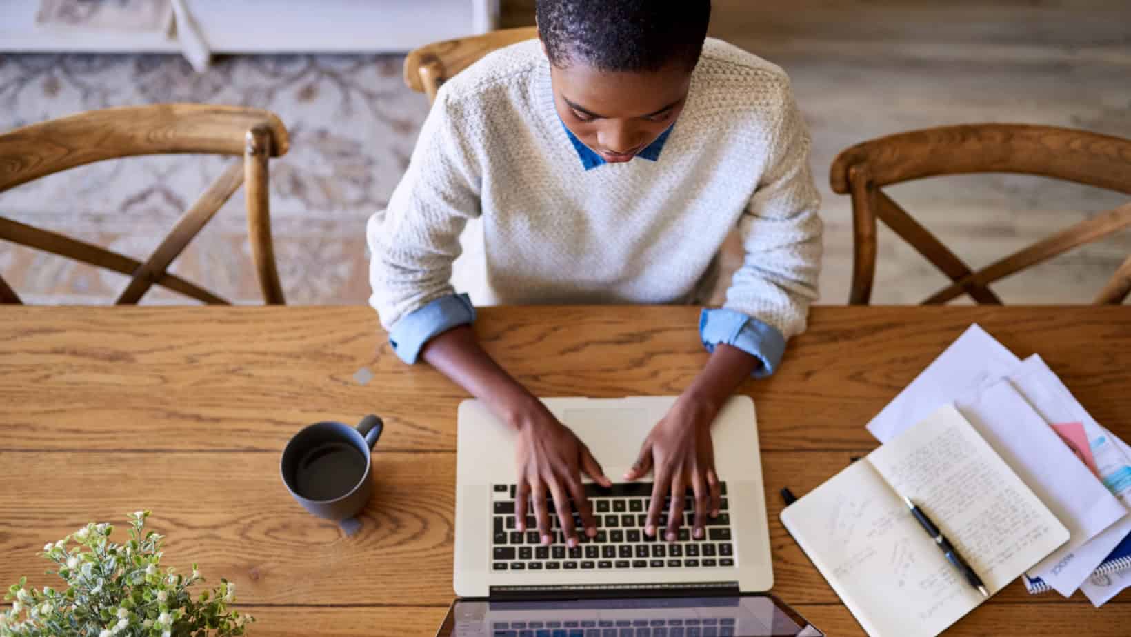 Empowered Black entrepreneur working on laptop for brand building and business growth.