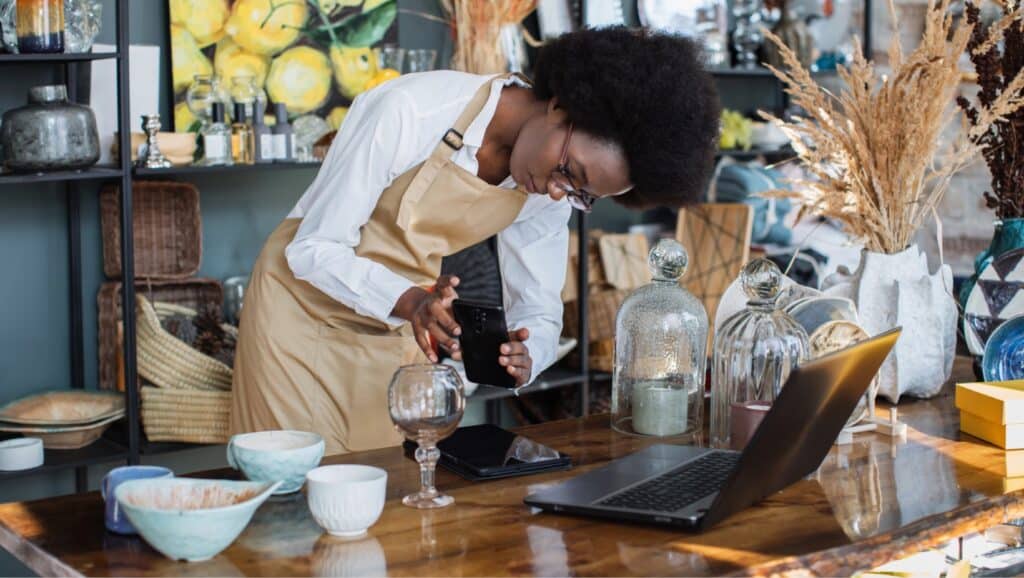 How to start a Black owned business online — entrepreneur packaging products at a home workspace