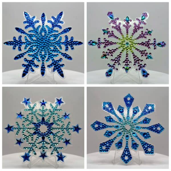 Blue snowflake ornament with intricate design and sparkling rhinestones, perfect for winter decor.