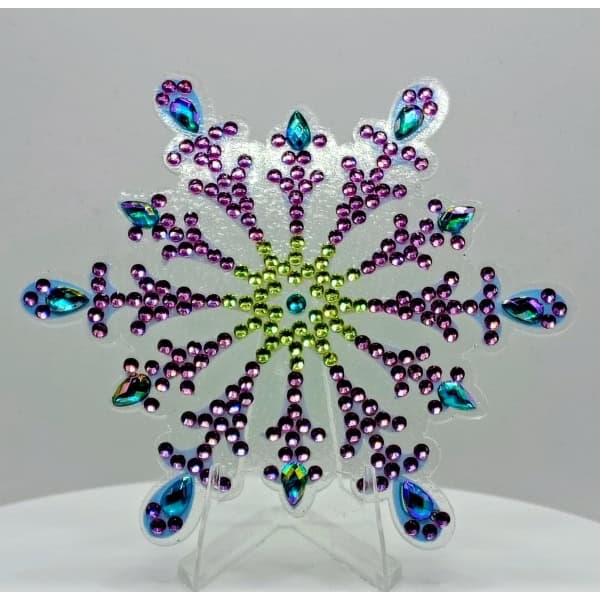 Brightly colored rhinestone snowflake ornament with purple, blue, and green accents for festive deco.
