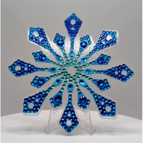 Blue rhinestone snowflake ornament for holiday decor and Black History Month celebrations.