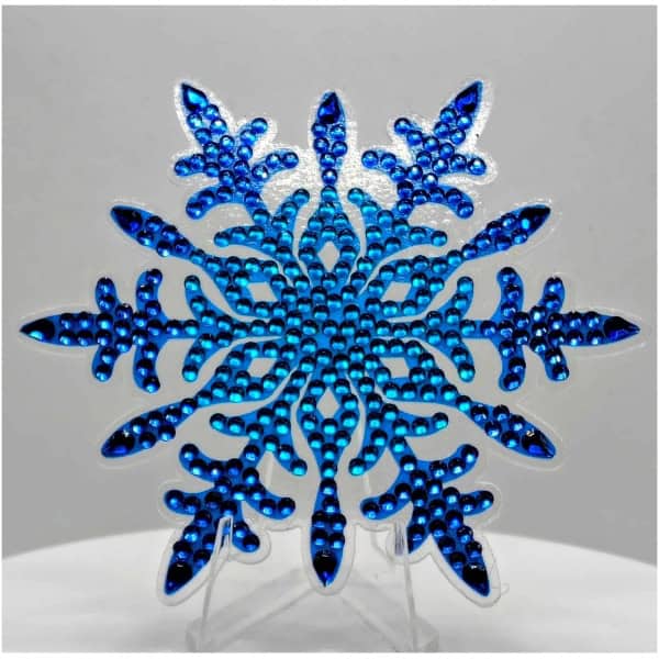 Blue snowflake ornament with intricate beadwork, symbolizing winter and cultural beauty.