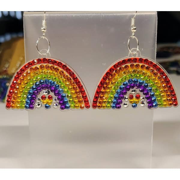 Rainbow earrings with multicolored rhinestones on silver hooks, displayed on a white background.