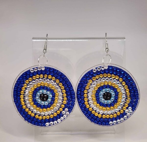 Bright circular beaded earrings with blue, gold, silver, and black accents, inspired by traditional.