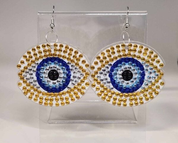 Beaded evil eye earrings with gold and blue accents, handmade jewelry accessory.