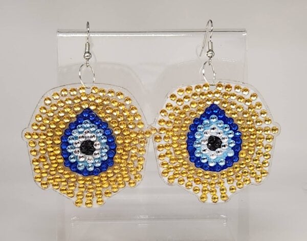 Beaded eye earrings with gold, blue, white, and black beads, handmade jewelry.