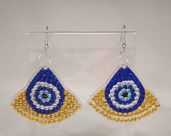 Bright blue, gold, and silver beaded earrings with a spiral pattern, displayed on a clear stand.