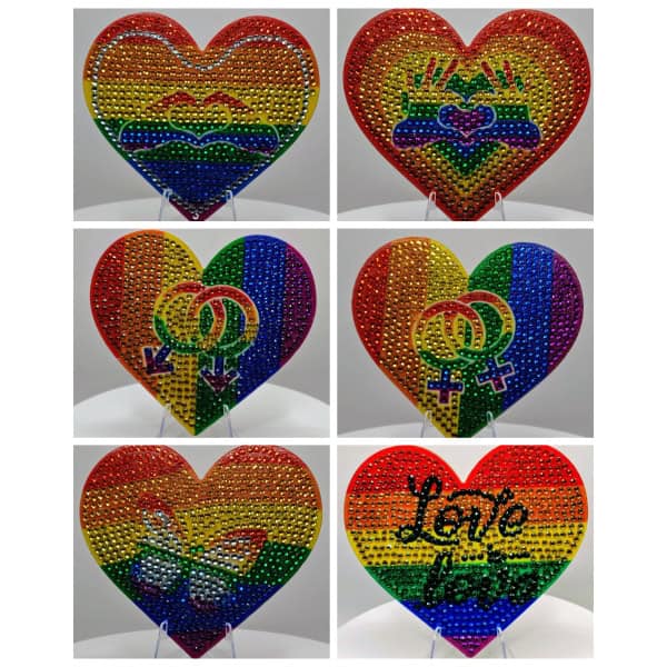 Rainbow heart-shaped decorative art with LGBTQ+ pride symbols and vibrant colors.
