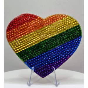 Rainbow heart-shaped art piece with multicolored rhinestones representing the LGBTQ+ pride flag.