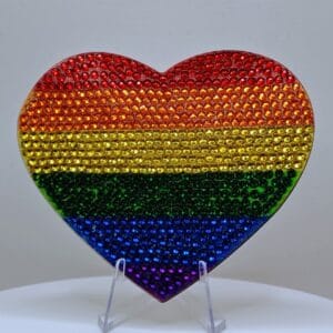 Rainbow heart-shaped jewelry piece with rainbow colors and rhinestone embellishments, symbolizing LG.