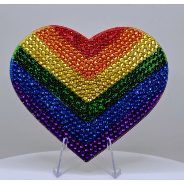 Rainbow heart decorated with colorful rhinestones representing LGBTQ+ pride and diversity.