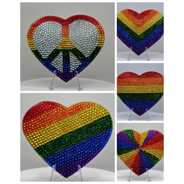 Rainbow heart with peace sign made of colorful rhinestones, symbolizing love and diversity.