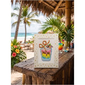 Colorful cross-stitch art of a tropical drink on a beachside bar.