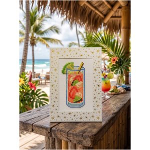 Colorful cross-stitch art of a tropical drink on a beachside table.